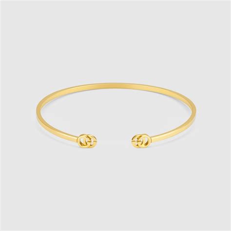 Gucci Bracciale rigido con GG Running in oro giallo